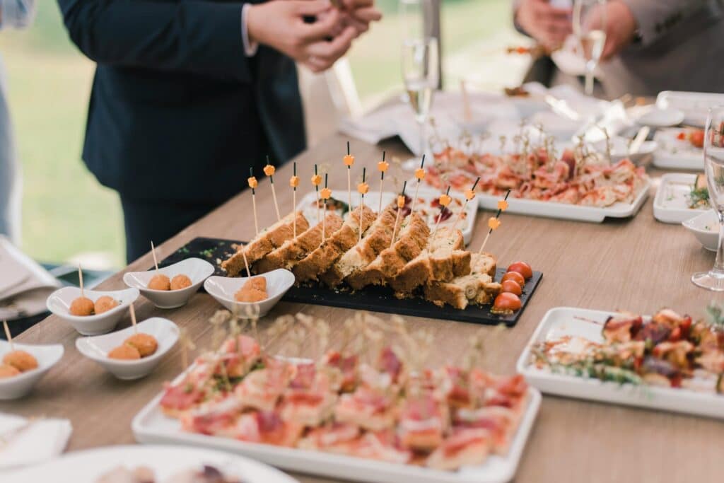 A variety of appetizers displayed elegantly on a buffet table at a social event.