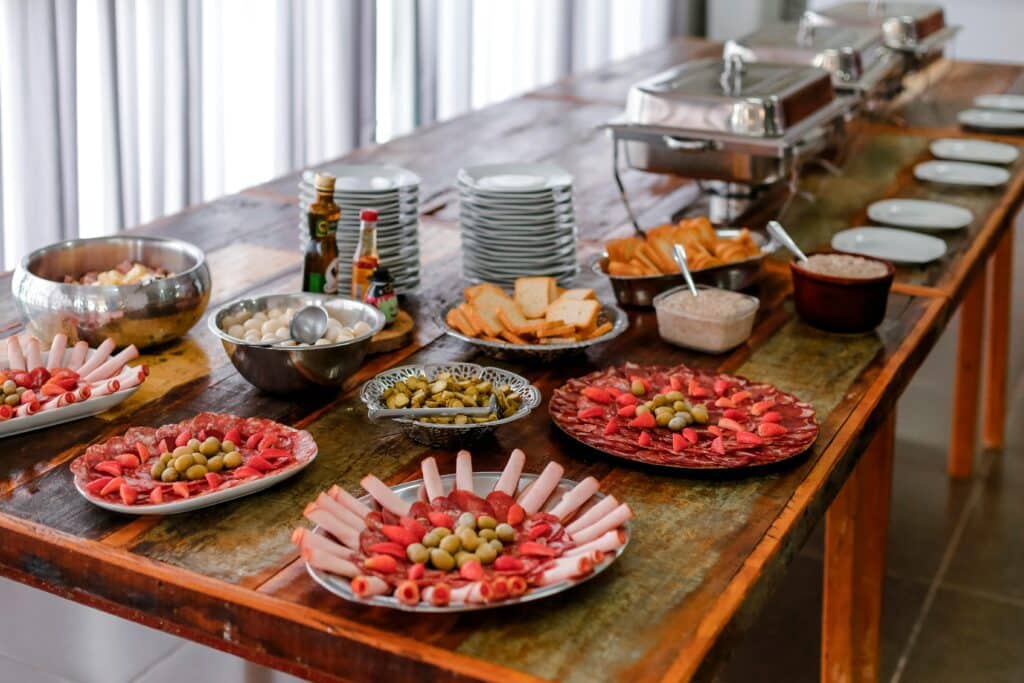 A sophisticated buffet spread featuring various meats, cheeses, and appetizers indoors.
